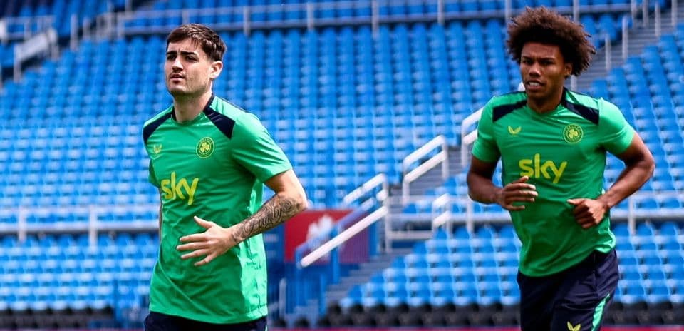 Two players jogging on training pitch