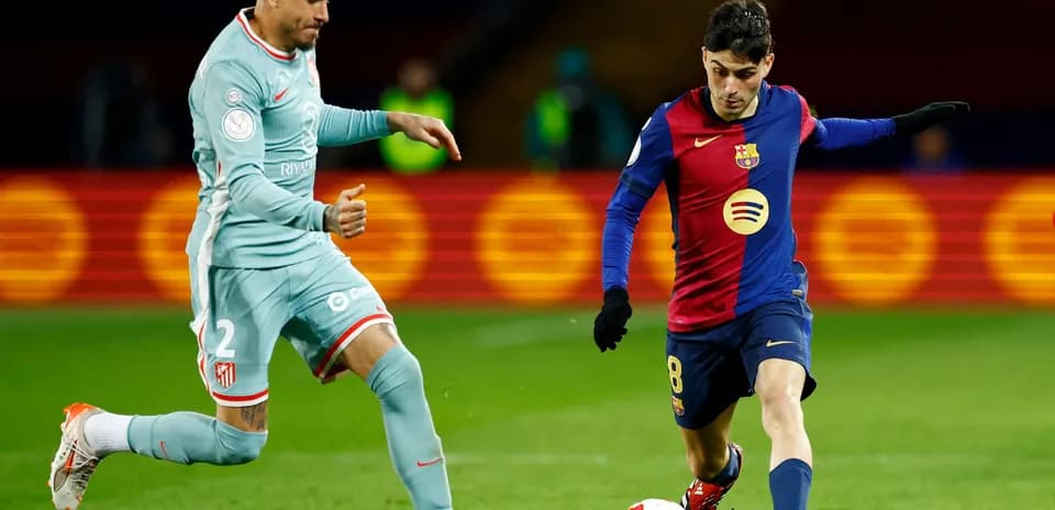 Atletico Madrid player challenging Barcelona midfielder