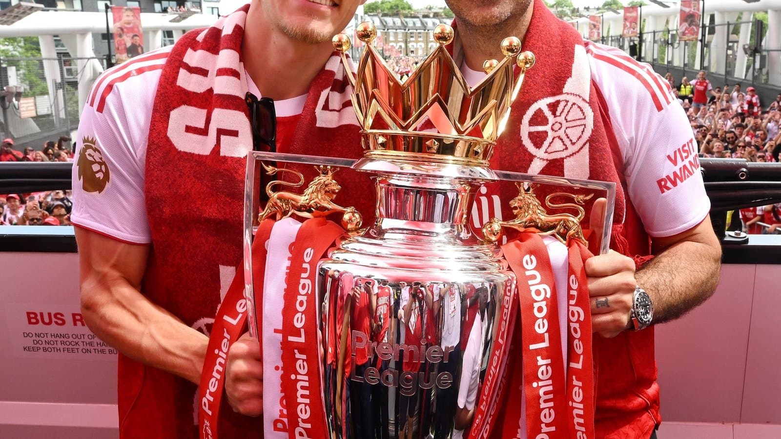 Two players celebrating with Premier League trophy