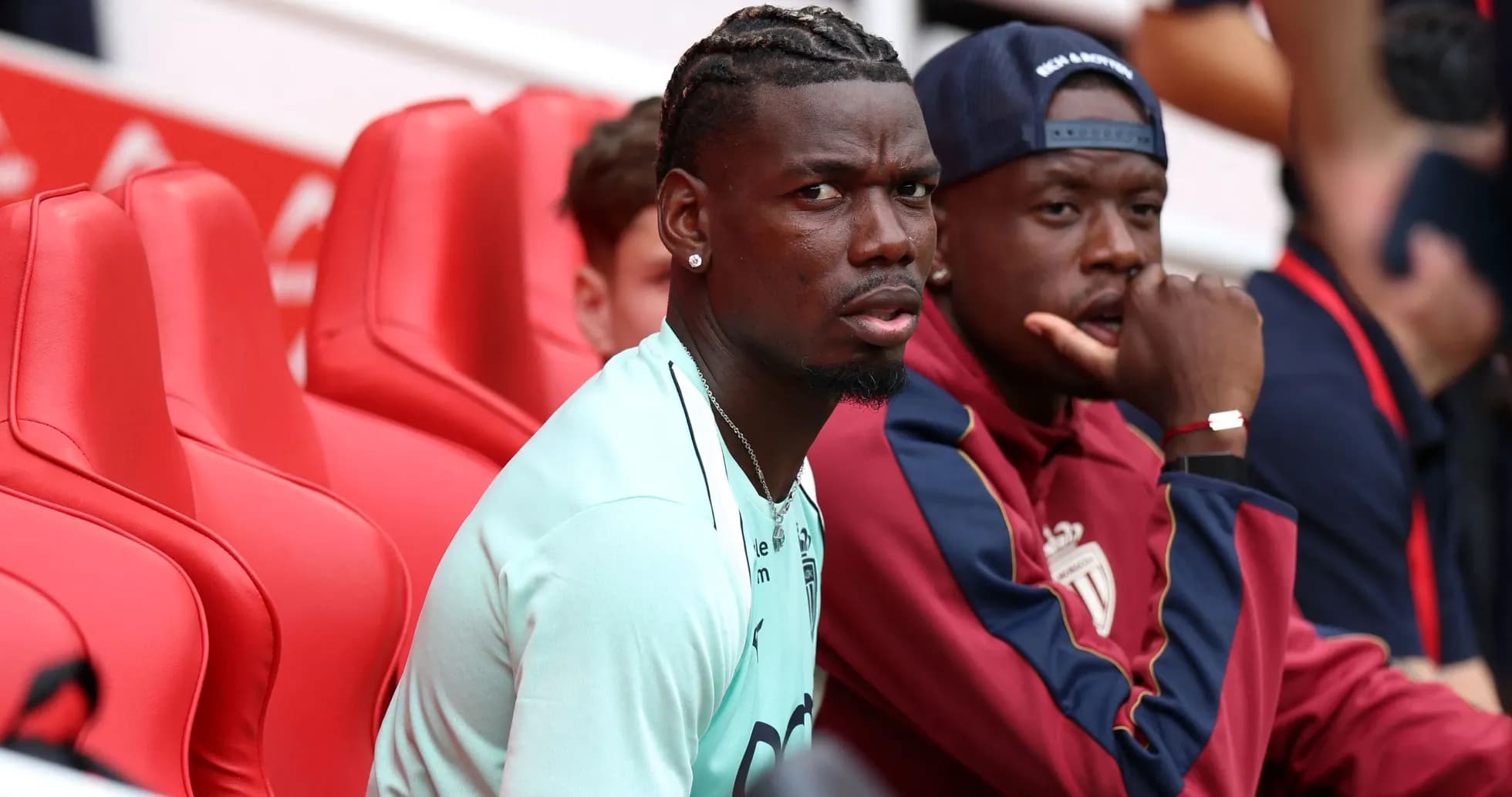 Two players sitting on bench during a match