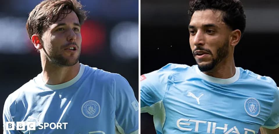 Two Manchester City players in blue kits