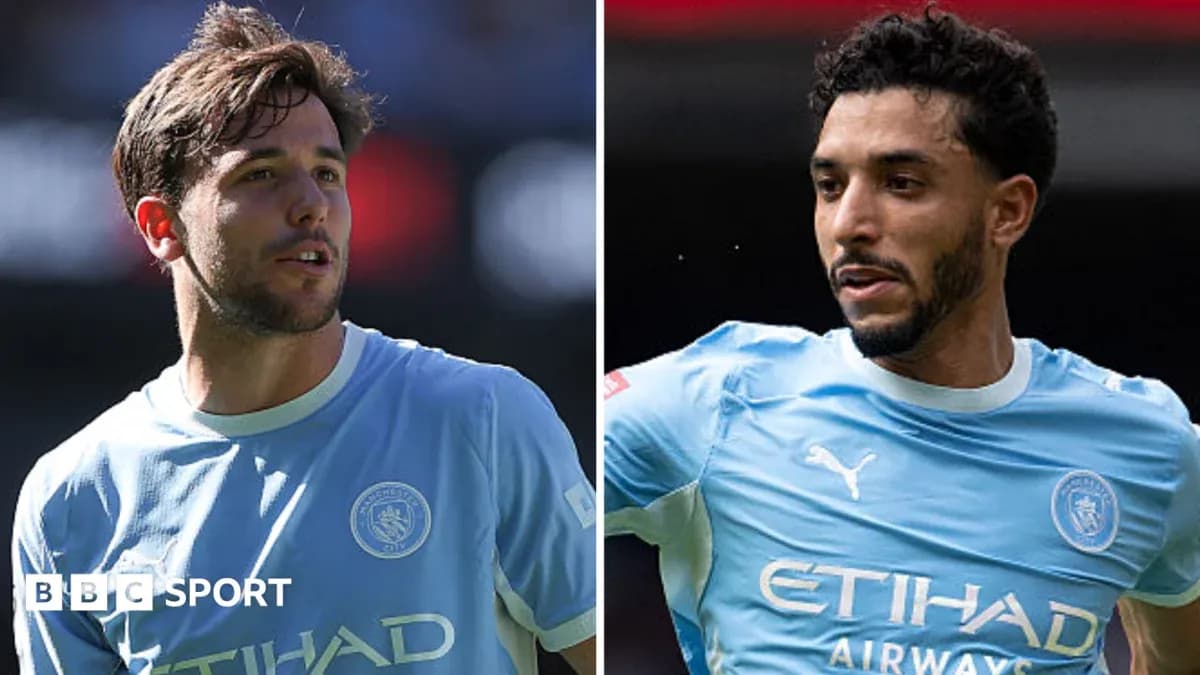 Two Manchester City players in blue kits