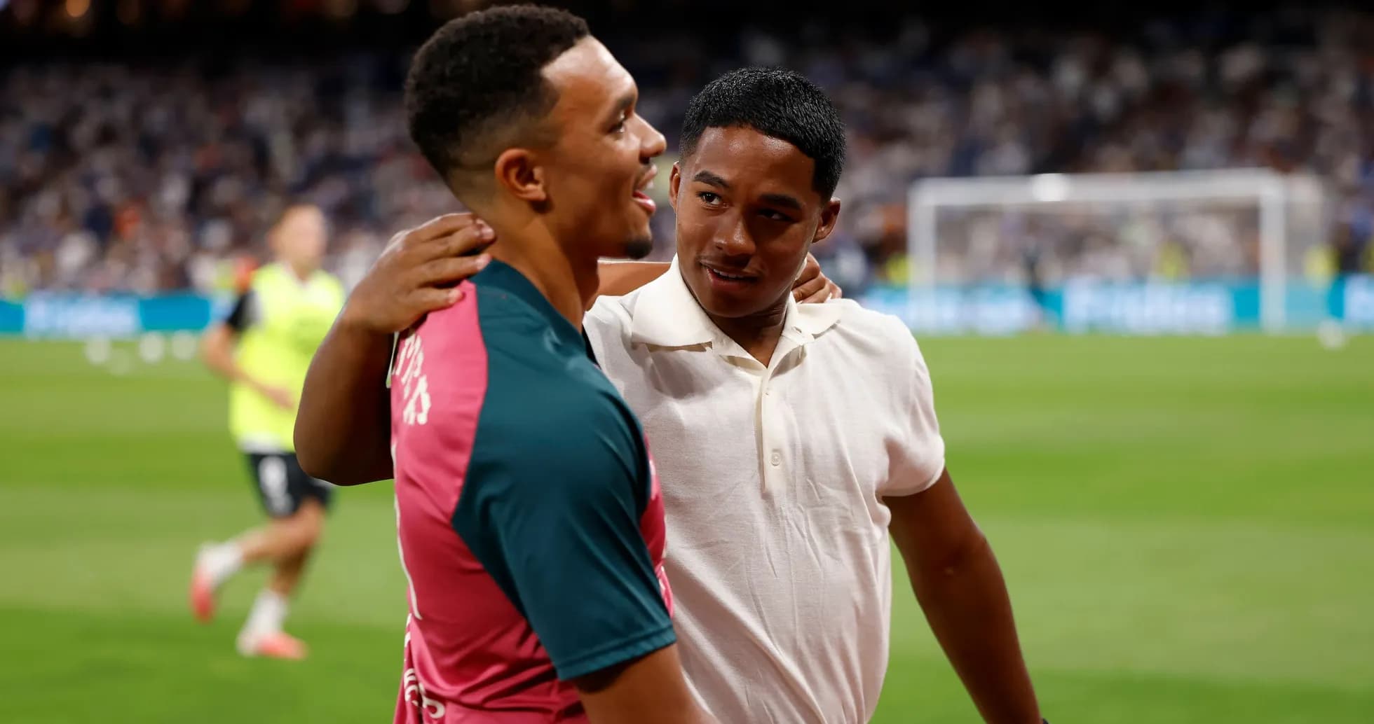 Two players embracing on the football field