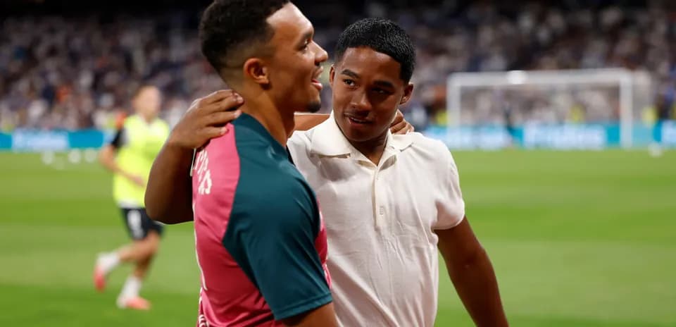 Two players embracing on the football field