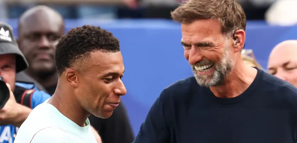 Kylian Mbappé and manager smiling during interaction