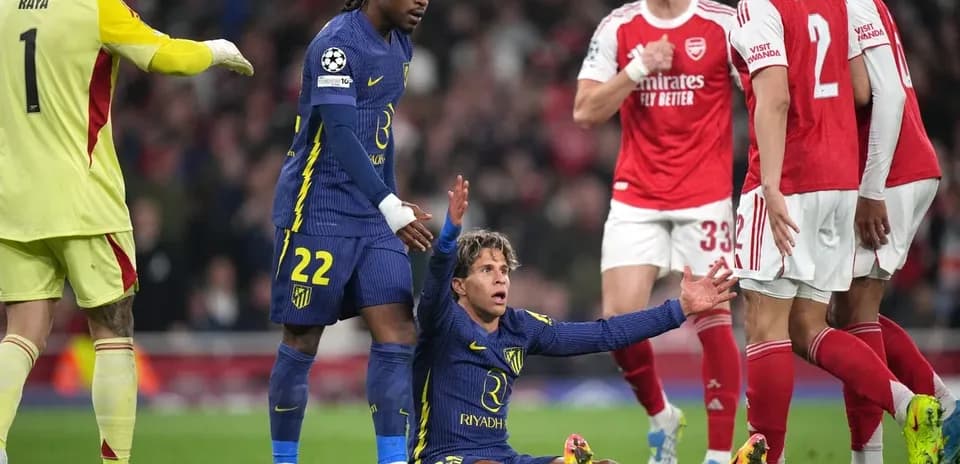 Player on ground with teammates and opponents nearby