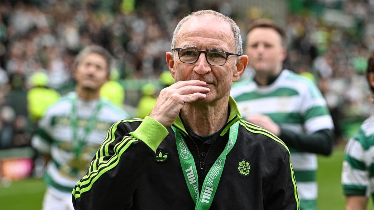 Manager with glasses on pitch after match