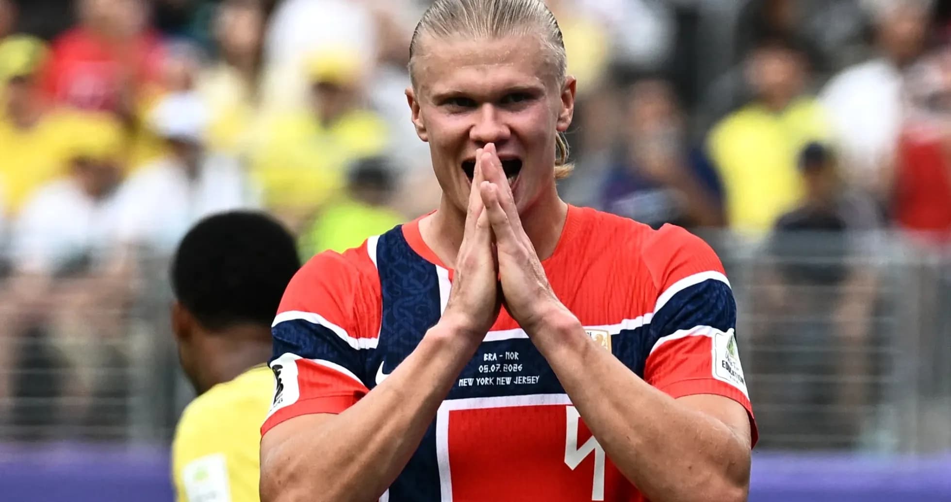 Player celebrating during match with fans in background