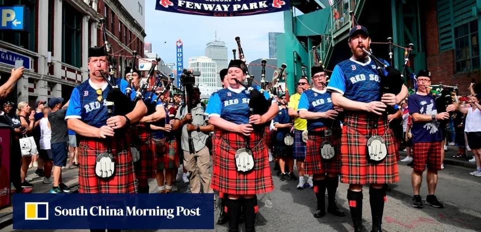Bagpipers in kilts marching outside Fenway Park