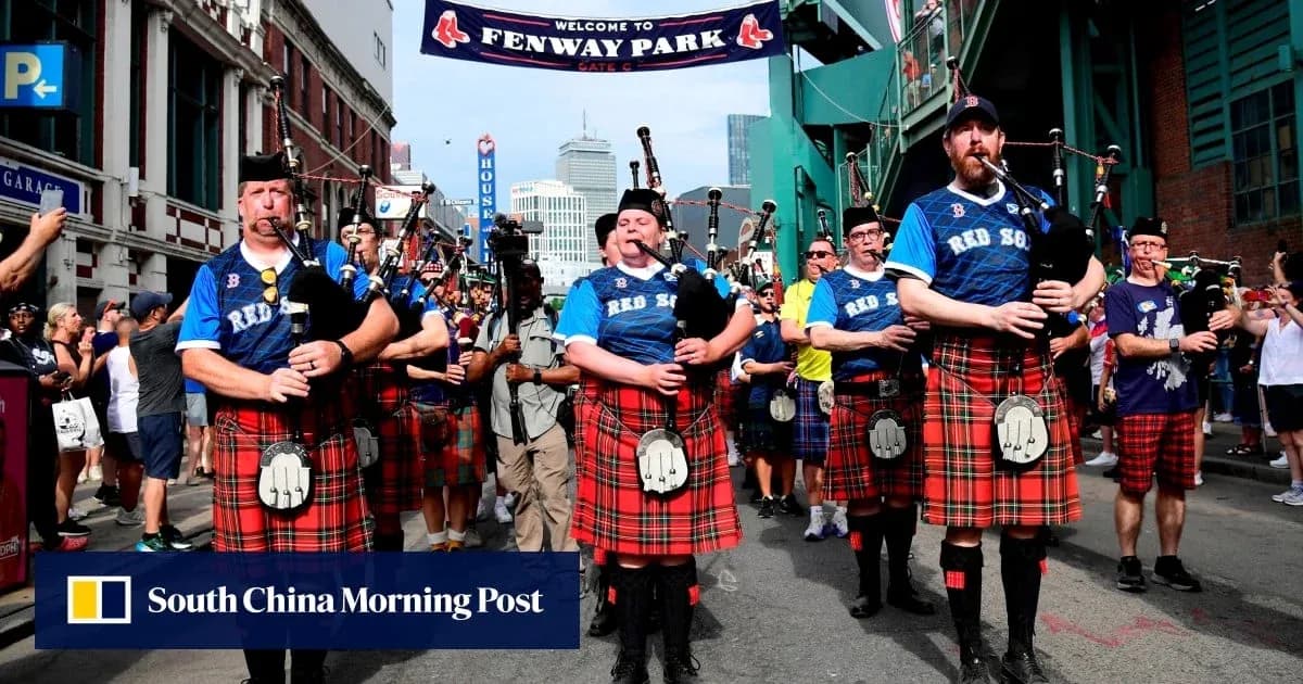 Bagpipers in kilts marching outside Fenway Park