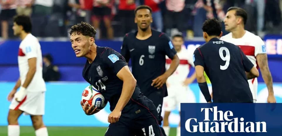 US player celebrating with ball after scoring goal