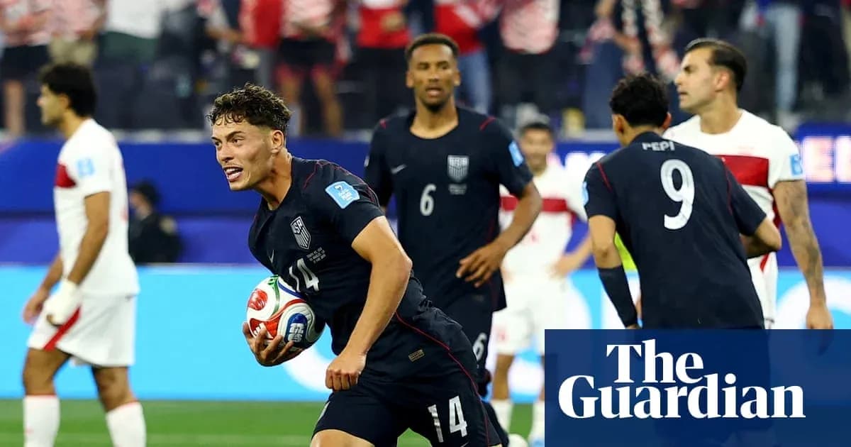 US player celebrating with ball after scoring goal