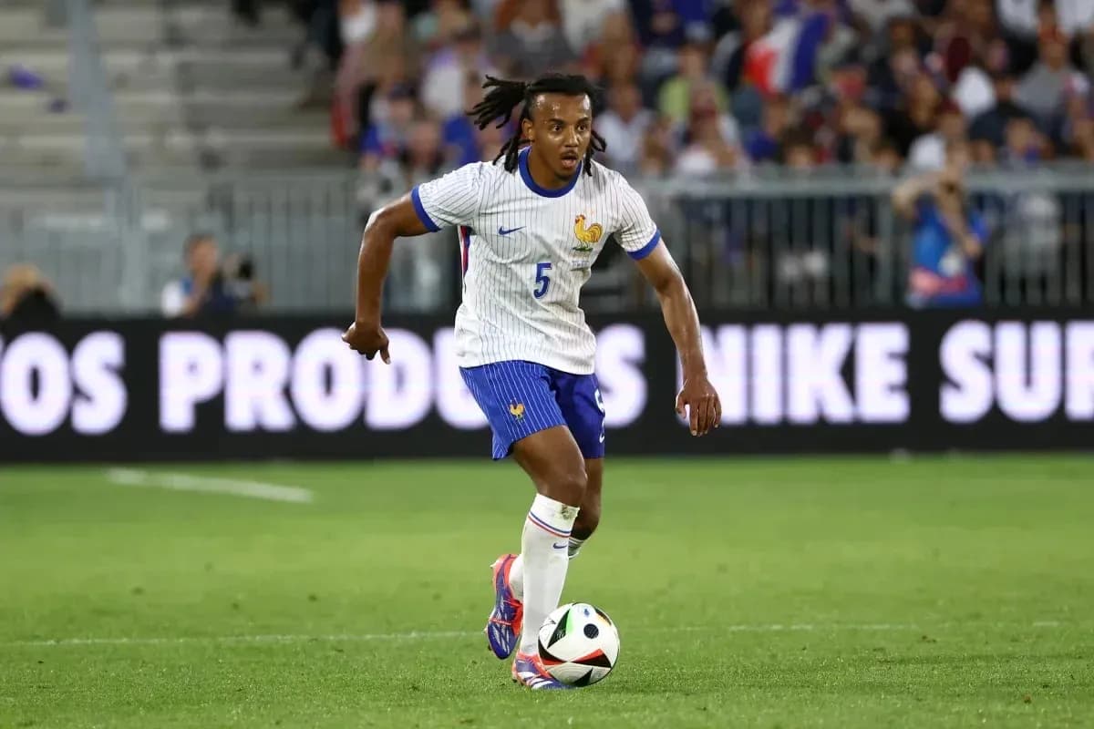 Player in France kit dribbling the ball on field