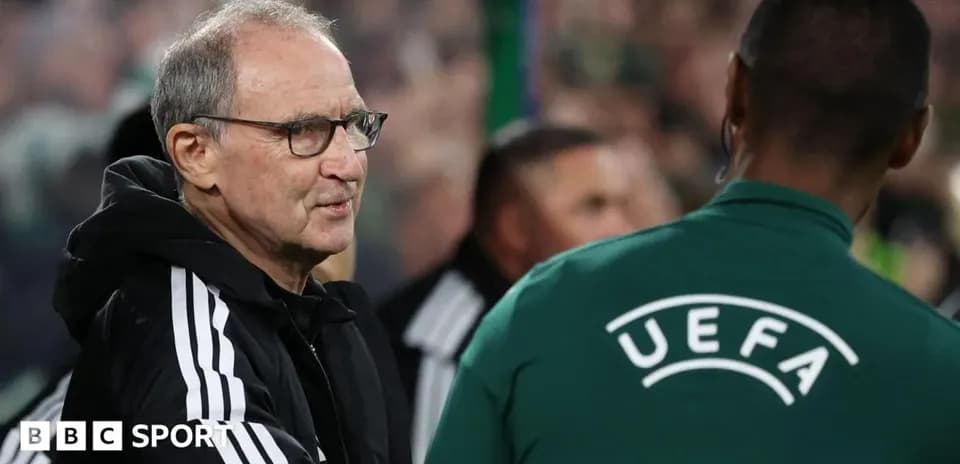 Coach interacting with UEFA official during match