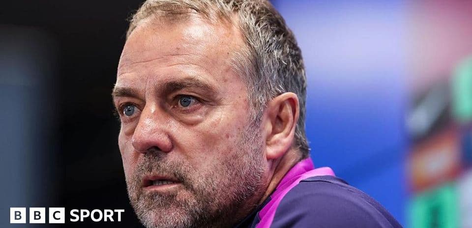 Coach speaking at press conference with serious expression