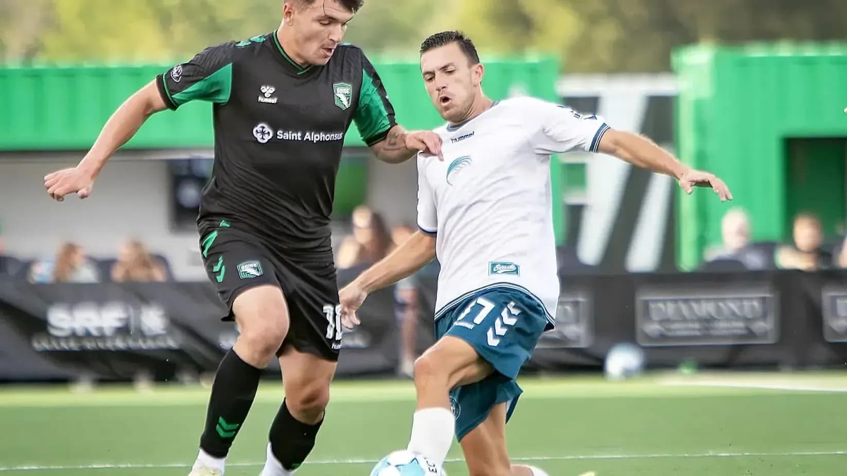Players competing for the ball in USL match