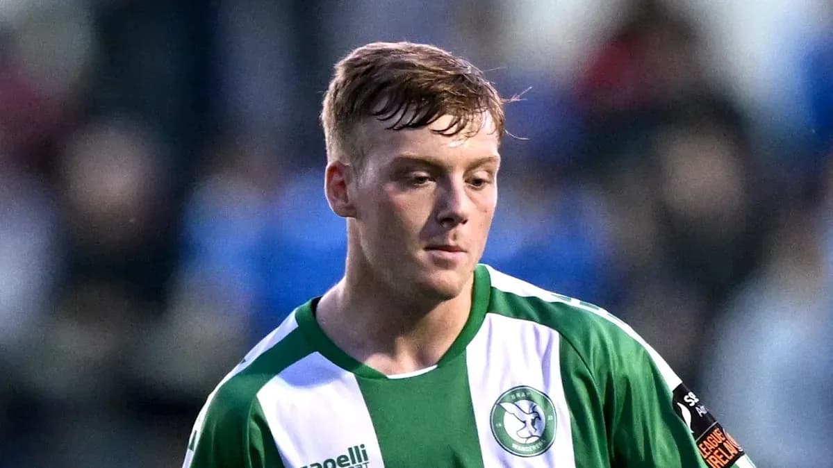 Player in green and white jersey on field
