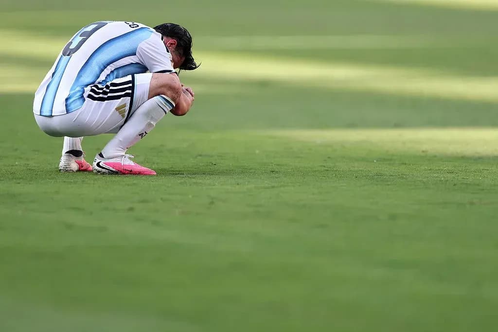 Player kneeling on field after match