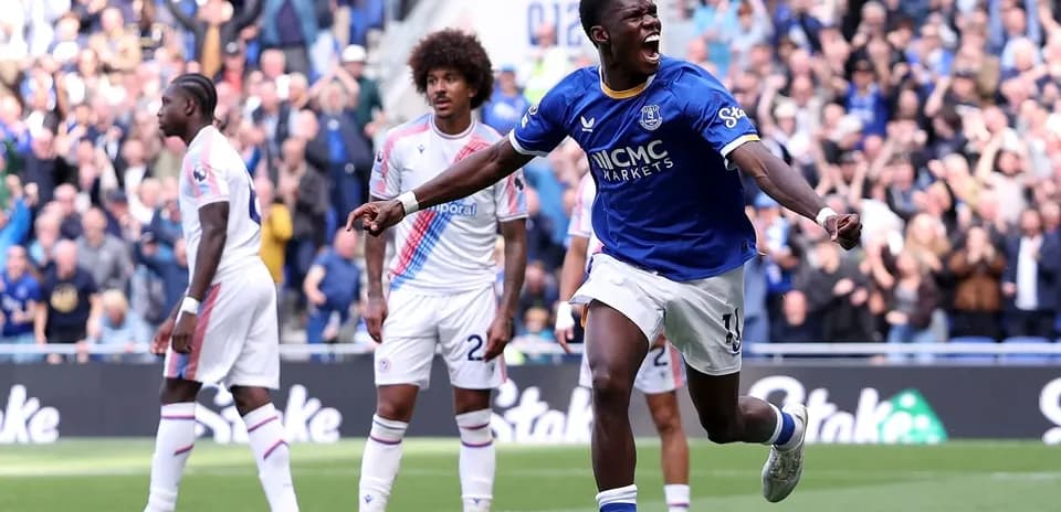 Player celebrating a goal with fans in background