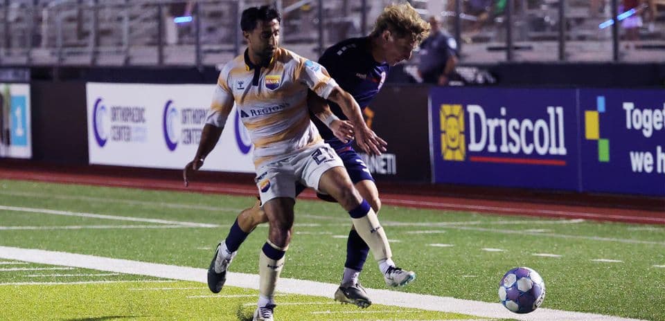Players competing for the ball during match