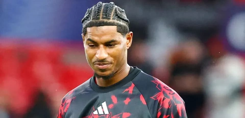 Player wearing Manchester United training kit on pitch