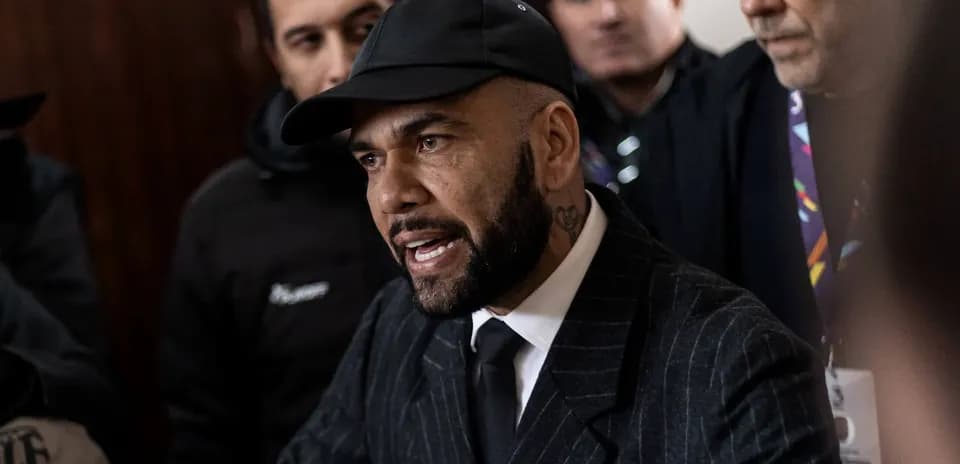 Man in suit speaking to crowd during event