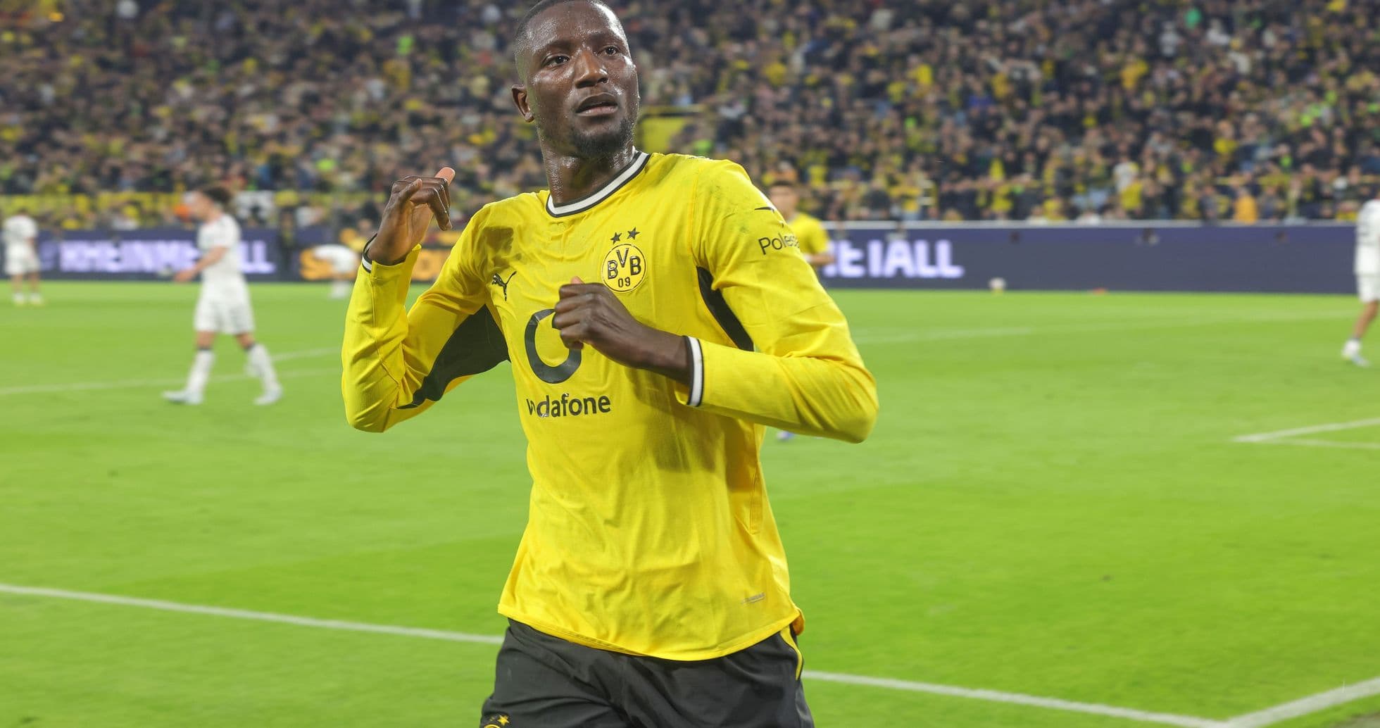 Player celebrating a goal in yellow Borussia Dortmund kit