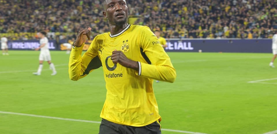 Player celebrating a goal in yellow Borussia Dortmund kit