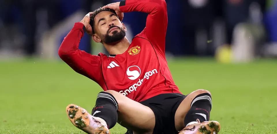 Player sitting on field, holding head in distress