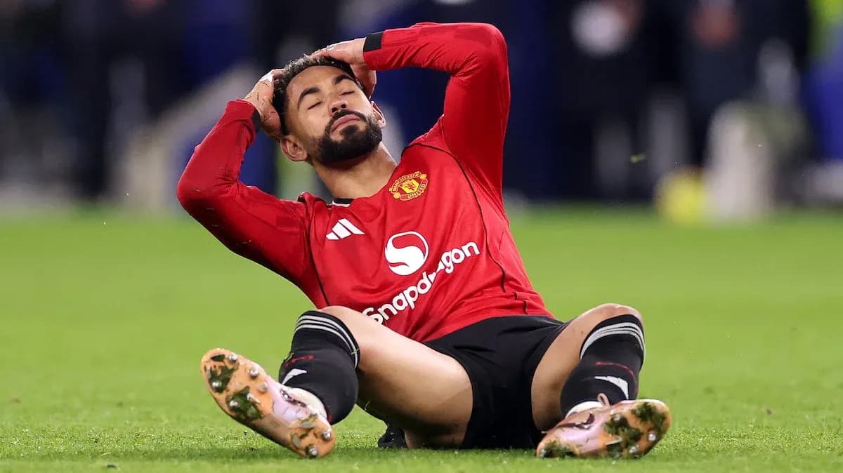 Player sitting on field, holding head in distress