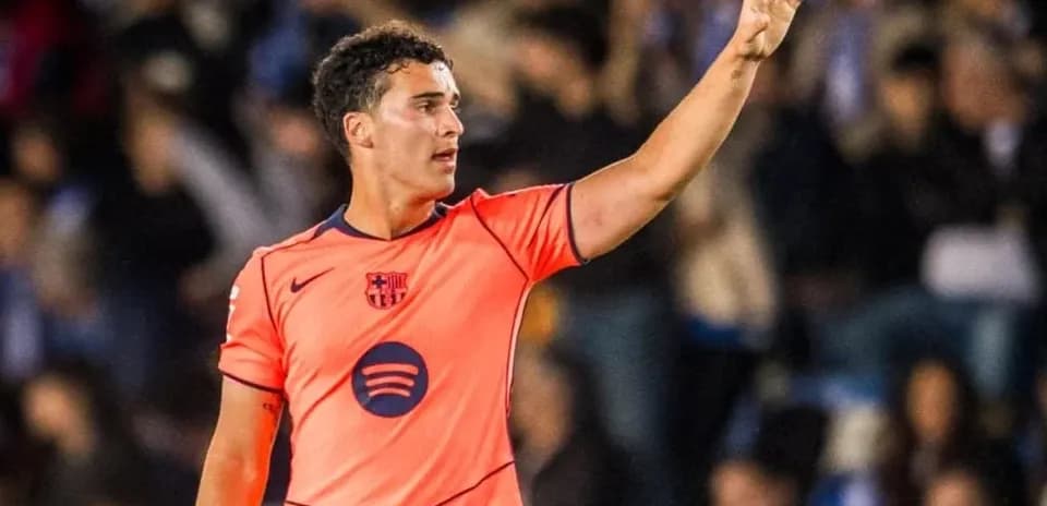 Player in orange jersey signaling during match