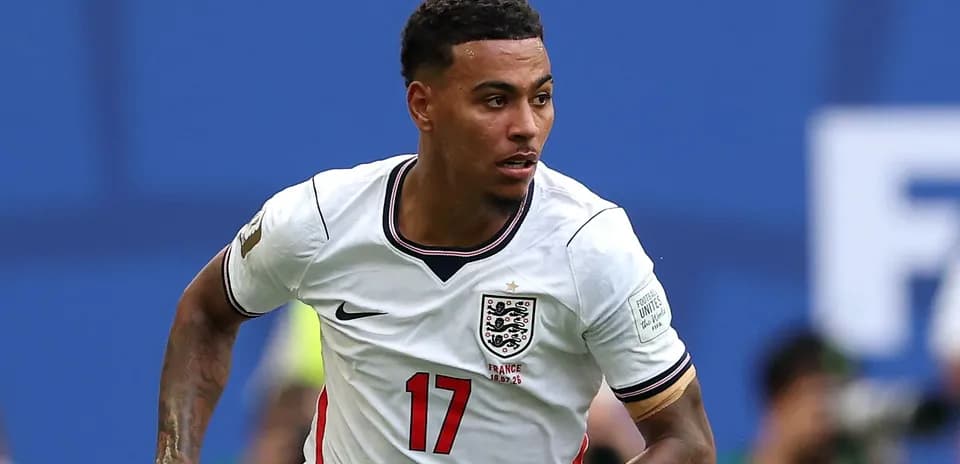 Player wearing England jersey running on the pitch