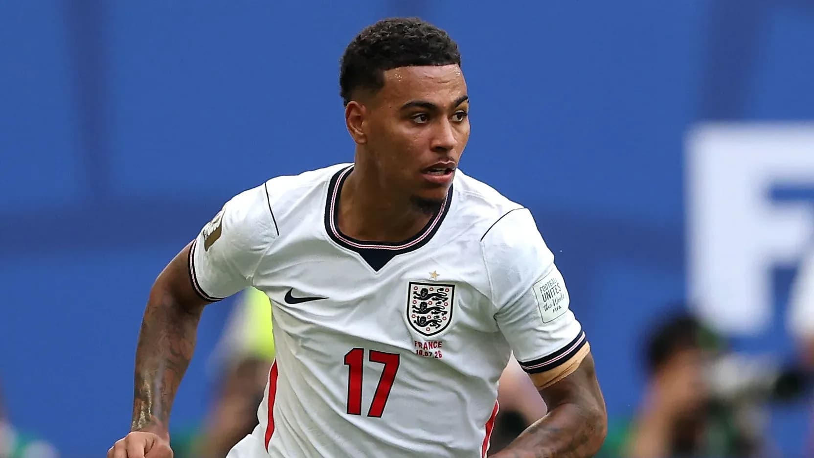 Player wearing England jersey running on the pitch