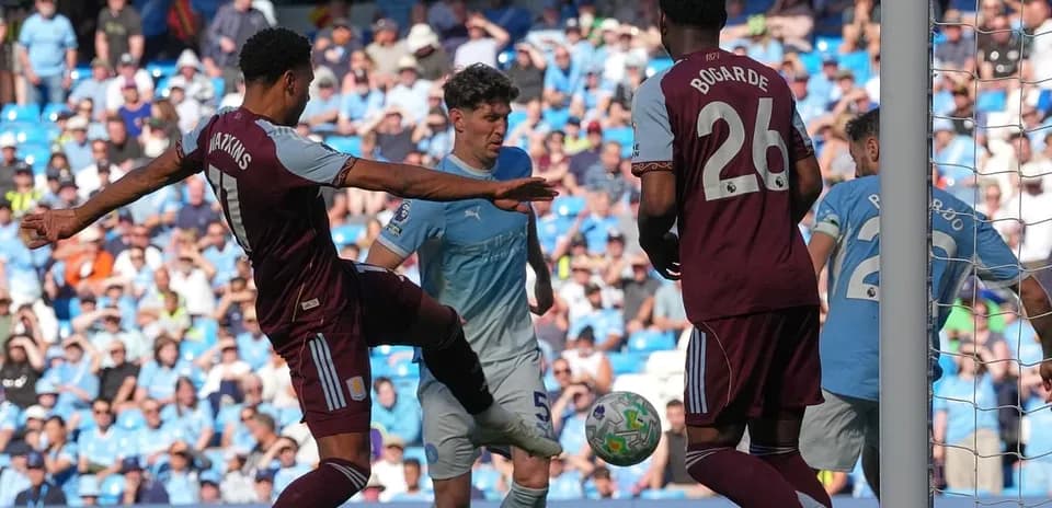 Players contesting the ball during Manchester City match