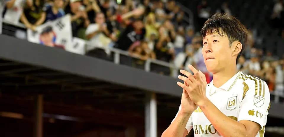 Player applauding fans in stadium during match