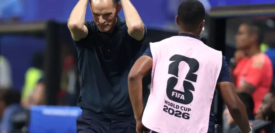 Coach holding head in frustration during match