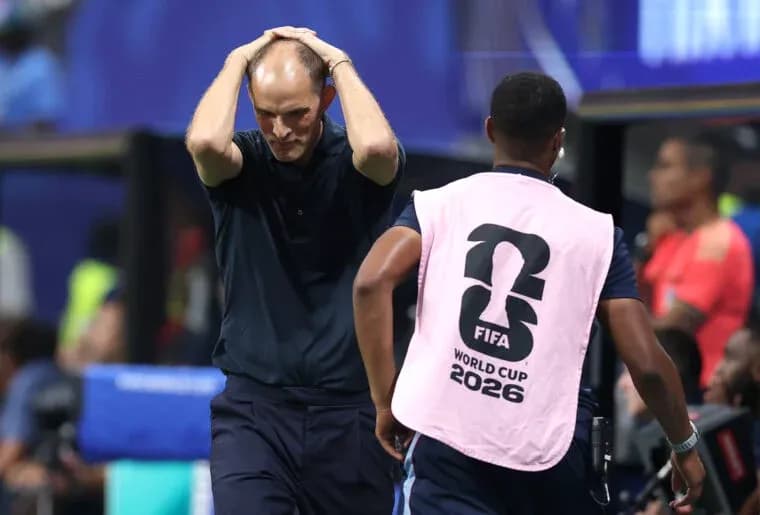 Coach holding head in frustration during match