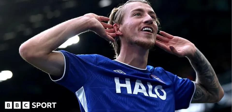 Player celebrating goal with hands to ears