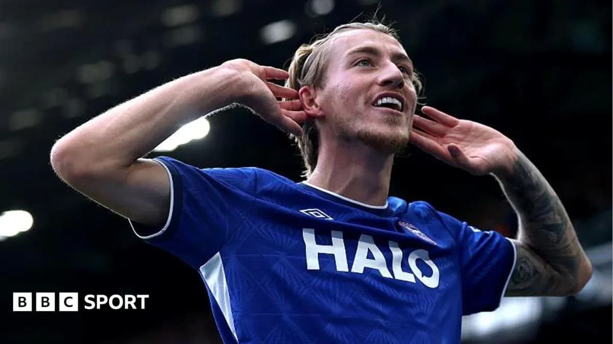 Player celebrating goal with hands to ears