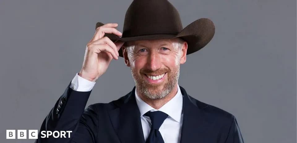 Man in suit tipping a cowboy hat