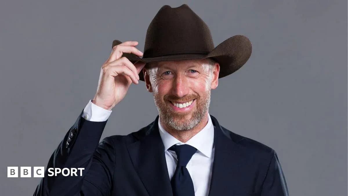 Man in suit tipping a cowboy hat