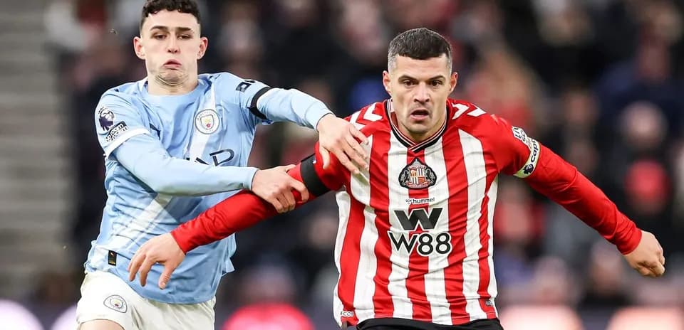 Phil Foden and Sunderland player in action