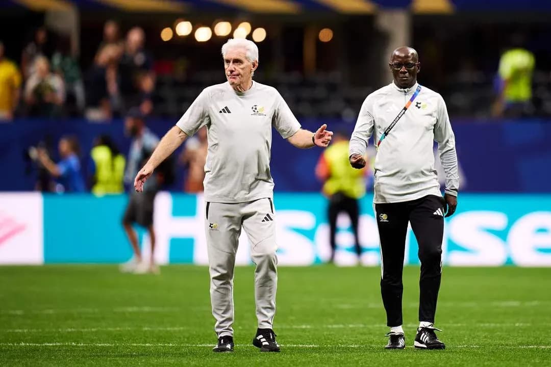 Coaches walking on the pitch before a match