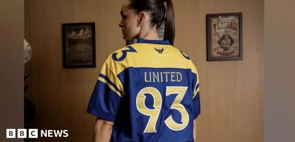 Person wearing a blue and yellow jersey with 'United' and number 93