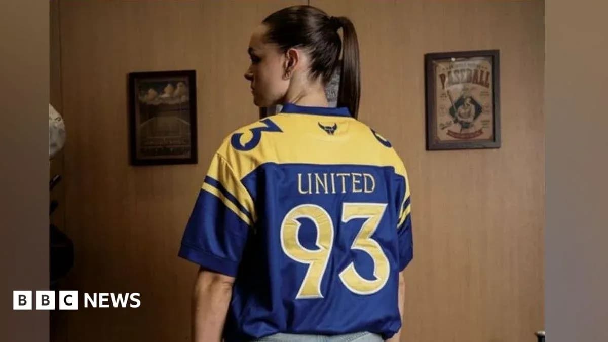 Person wearing a blue and yellow jersey with 'United' and number 93