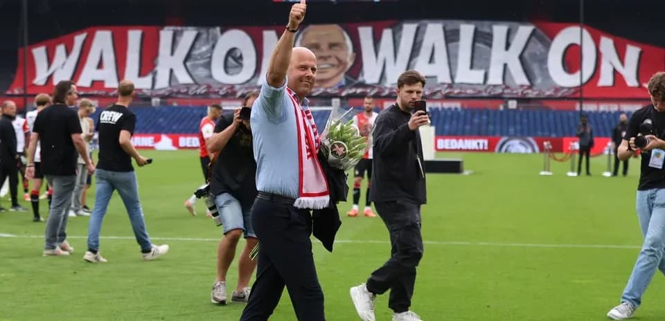 Man waving with bouquet on football pitch