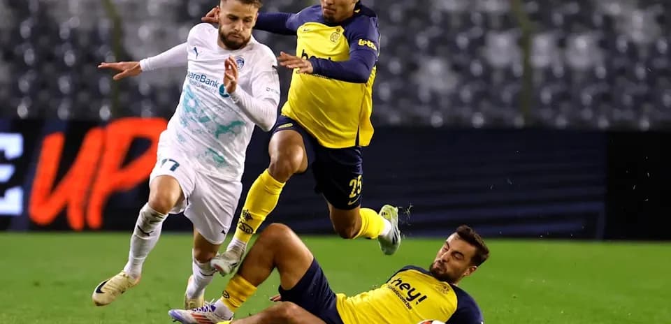 Player evading two defenders during a football match