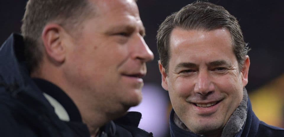 Two men conversing during a sporting event