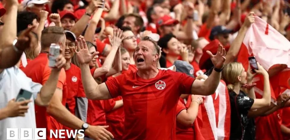 Fans celebrating in red attire during a match