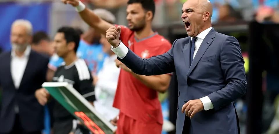 Manager celebrating during a football match on sidelines
